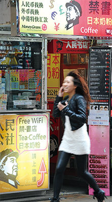 香港曾有「禁書天堂」之稱,但在國安法實施後中共官場的「政治禁書」已絕跡。圖為2010年3月17日香港一家人民幣兌換點也販售禁書。(Mike Clarke/AFP)