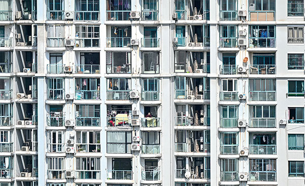 長達數星期的封城措施，使得上海老百姓陷入嚴重的斷糧危機。圖為4月8日，上海靜安區一棟遭封鎖的住宅樓。（Hector Retamal / AFP）